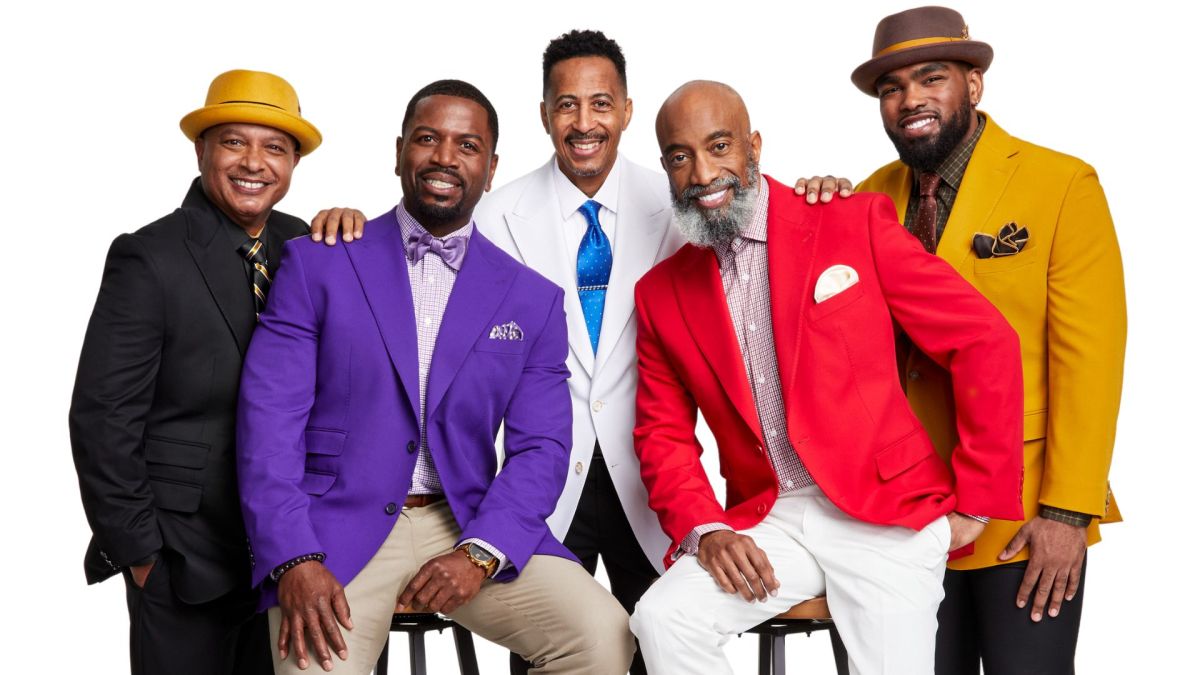 Divine Nine fraternity and sorority members in coordinated colors at a public event