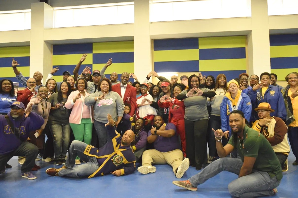 Divine Nine Greek organization members together on a college campus