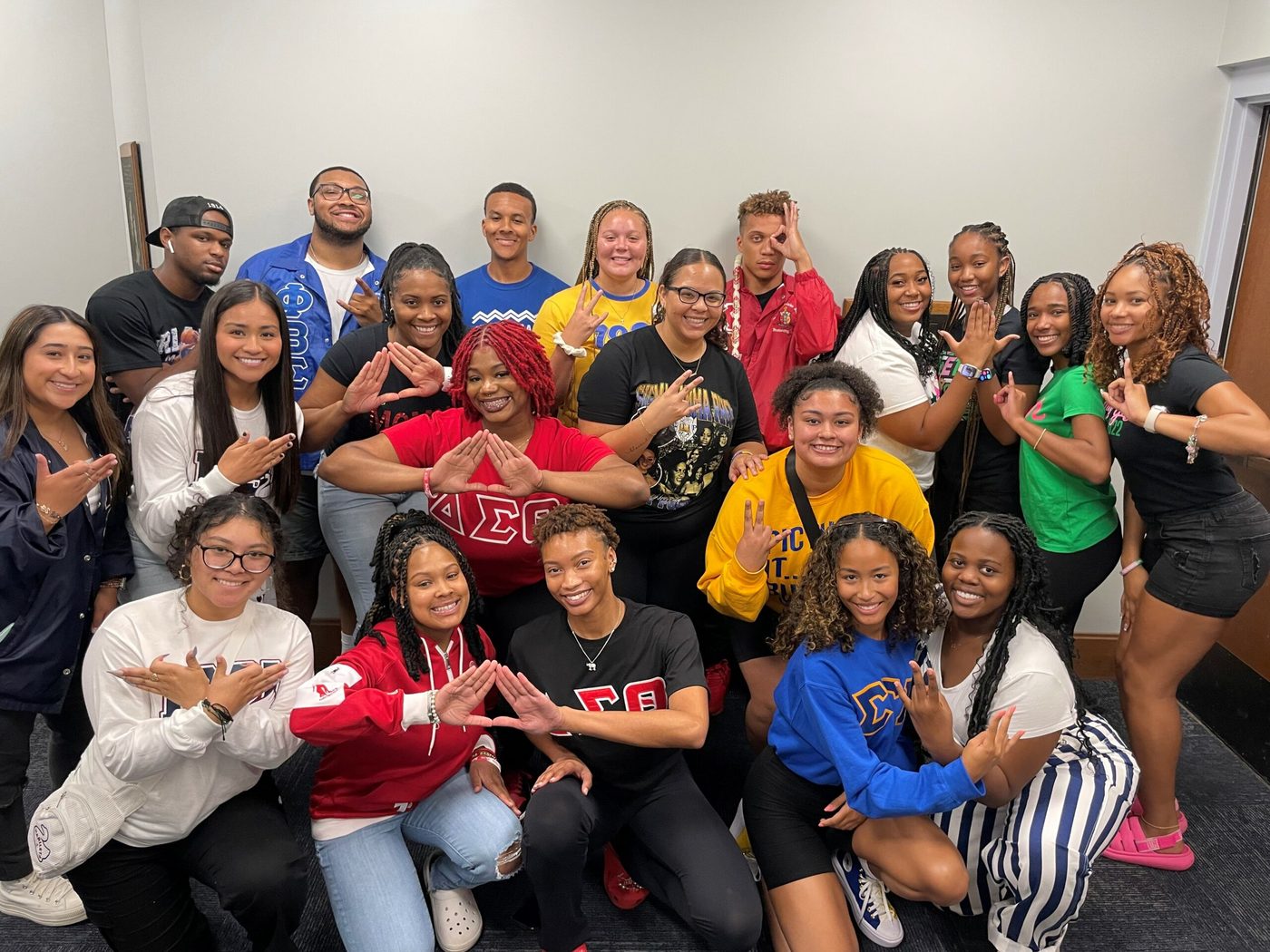 NPHC group portrait of fraternity and sorority members on a college campus