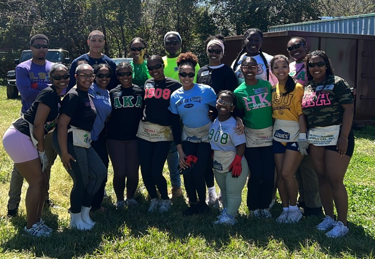 NPHC Divine Nine members PWI campus service event Greek life