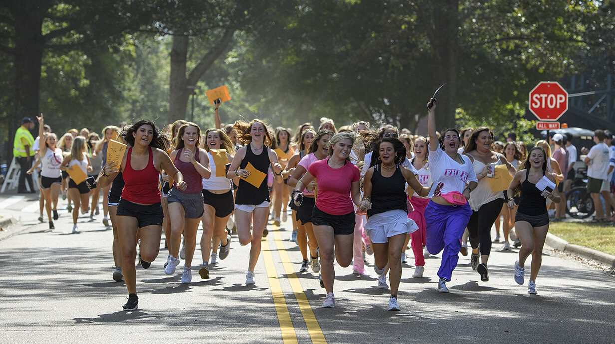 NPHC and Panhellenic sorority recruitment side by side on a college campus