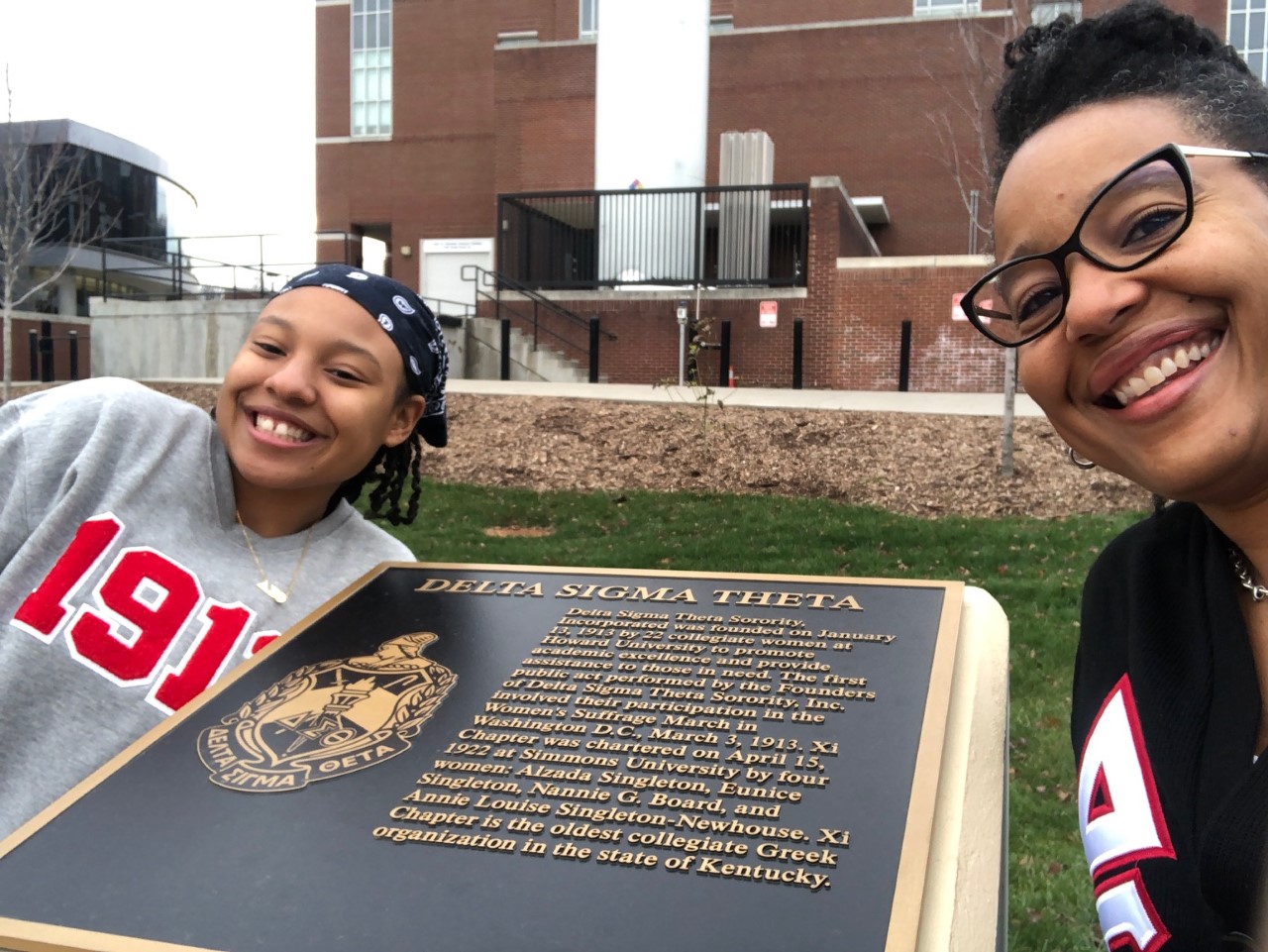 Returning Greek member smiling with sister at chapter event