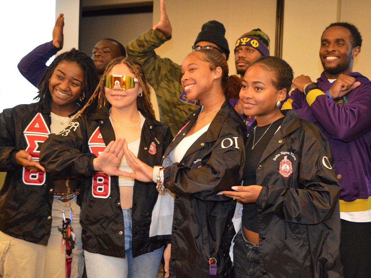 Divine Nine members wearing Delta Sigma Theta, Omega Psi Phi and Sigma Gamma Rho letters
