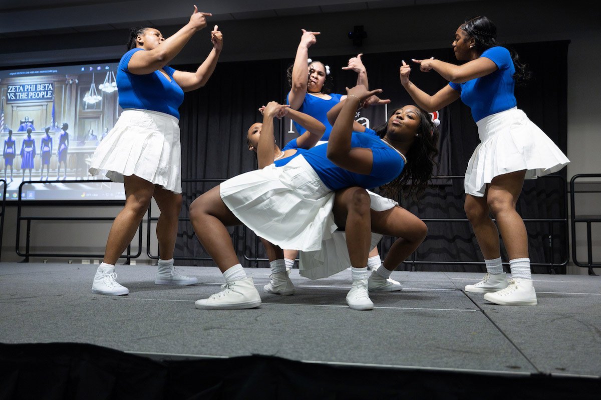 Zeta Phi Beta members performing a synchronized stroll on stage