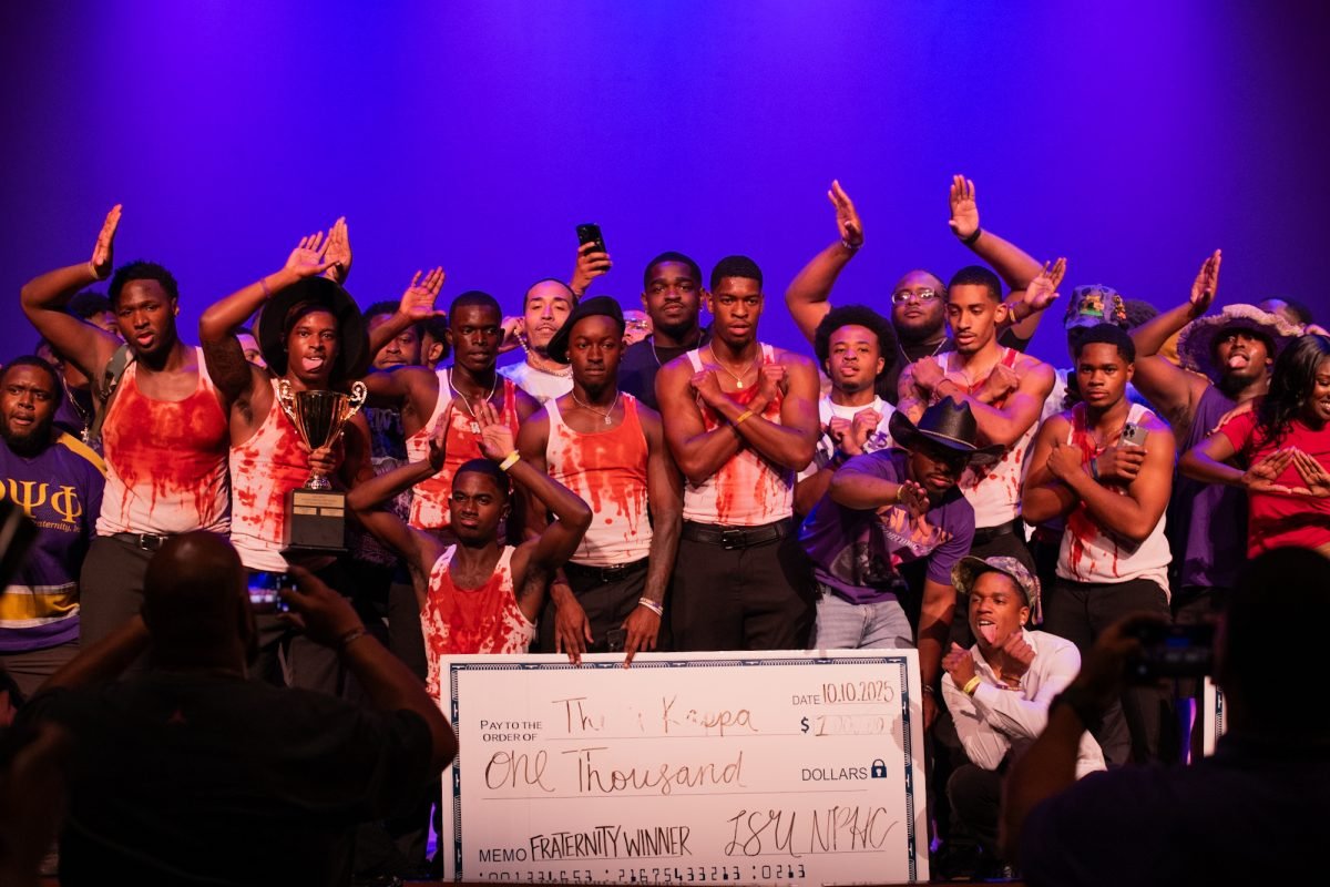 Divine Nine fraternity members celebrate on stage at an NPHC step show