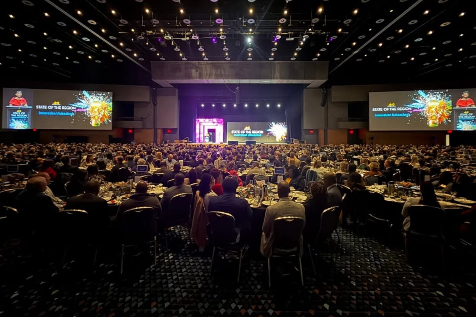 Members and delegates seated at a large convention session