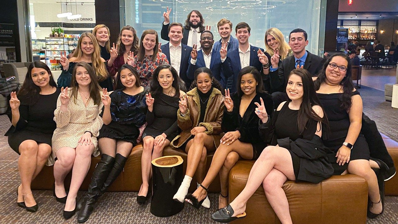 Fraternity and sorority members dressed up together at a formal banquet