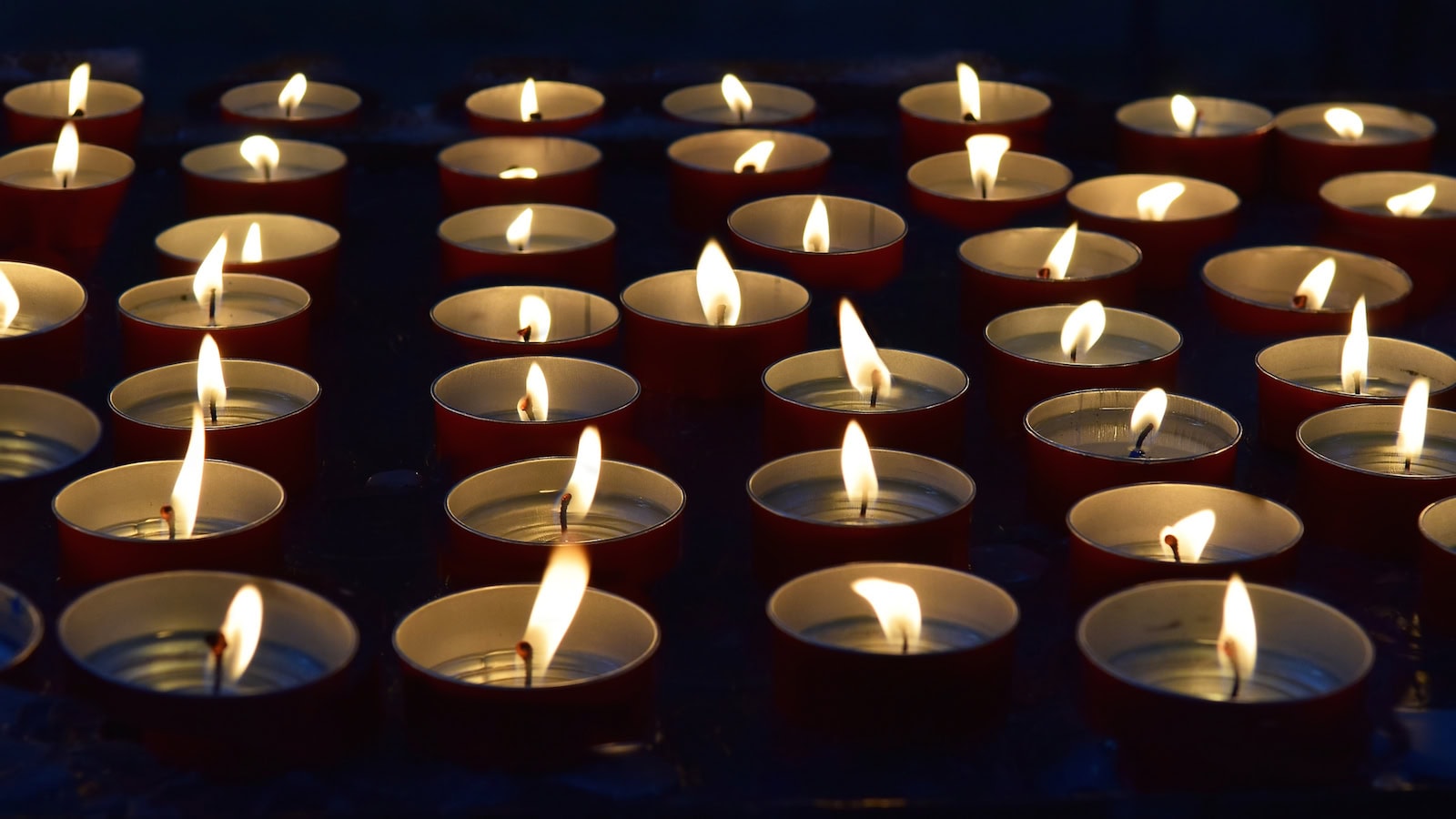 A lit memorial candle symbolizing remembrance