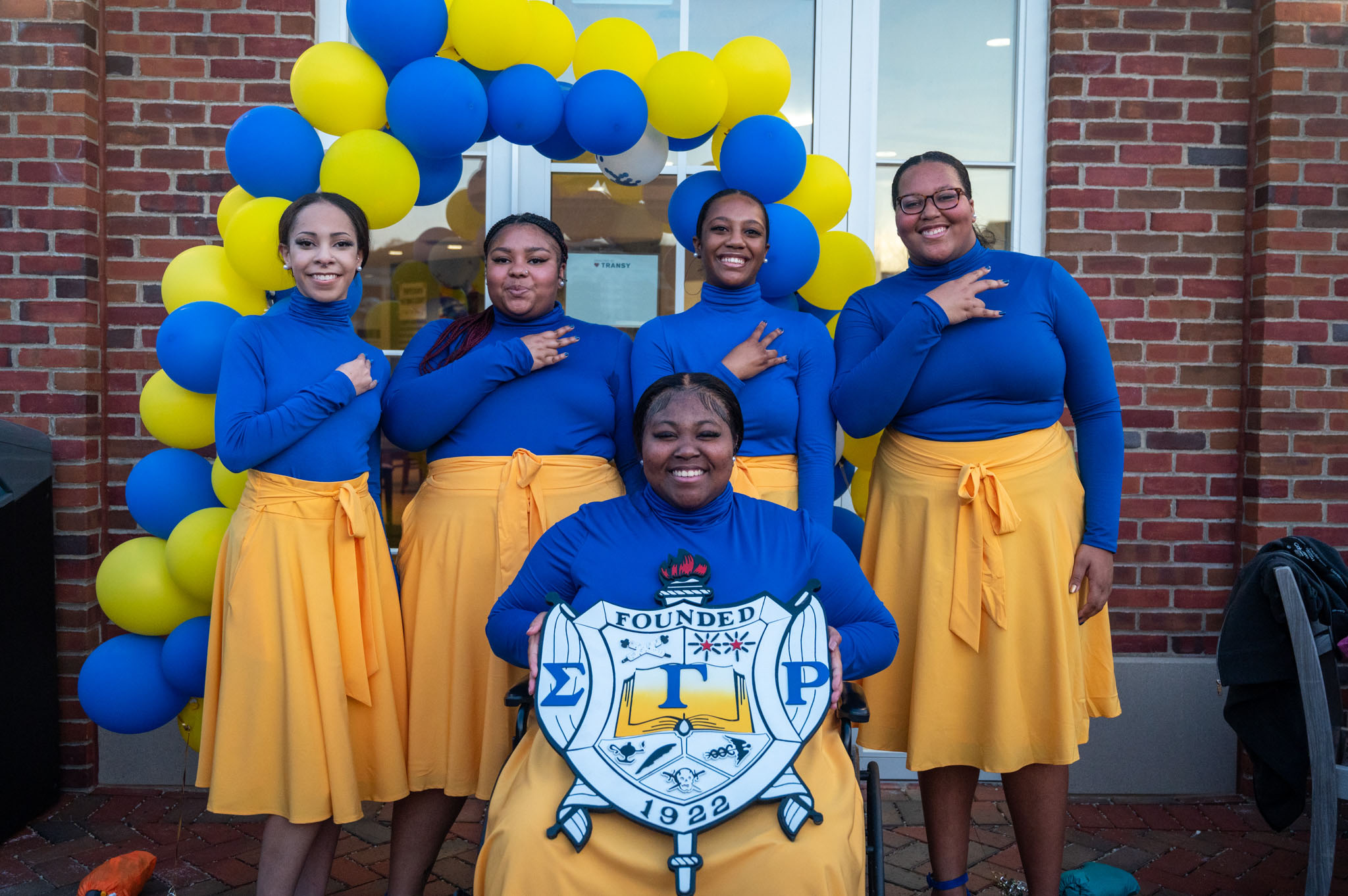 Sigma Gamma Rho members celebrating in royal blue and gold