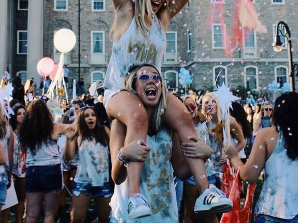 Sorority sisters celebrating together with confetti at an outdoor event